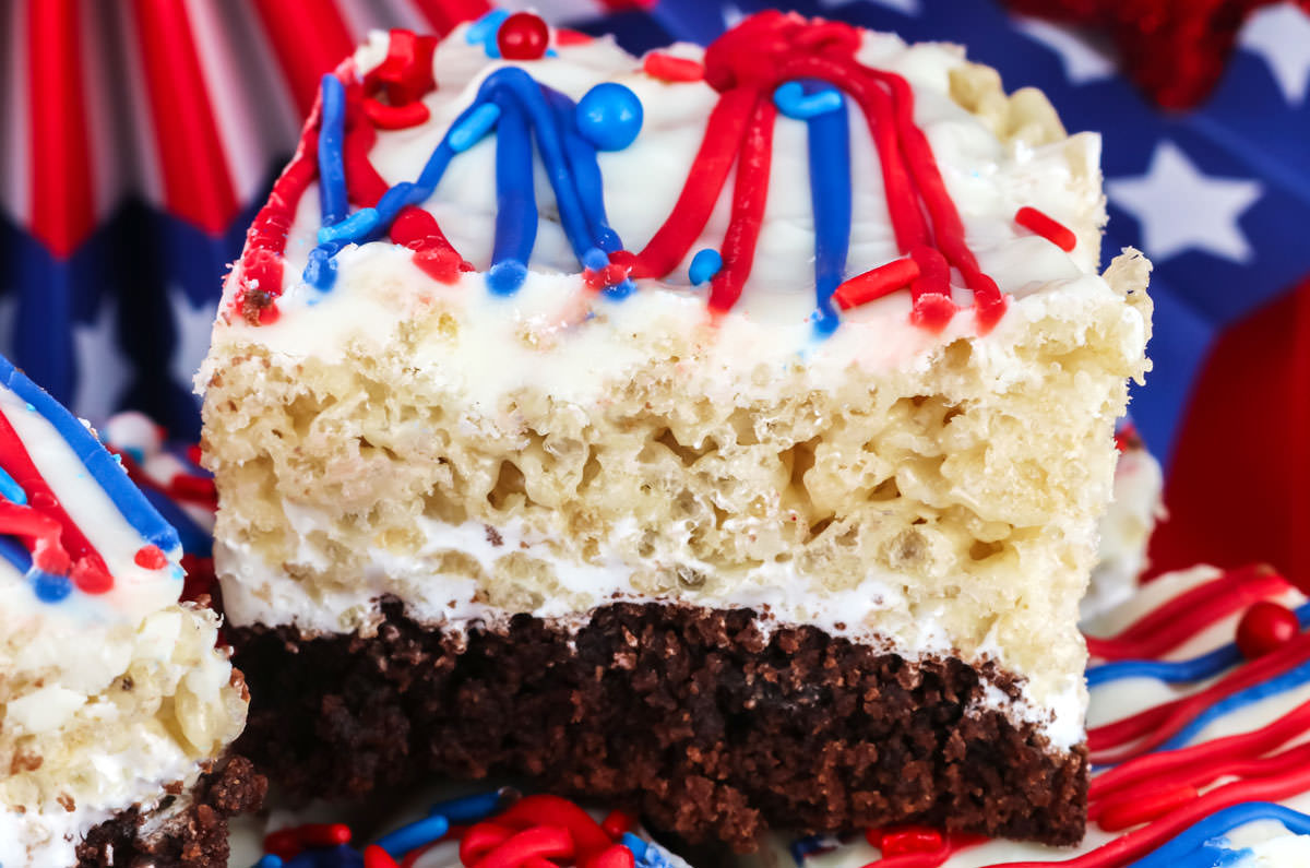 Closeup on a Patriotic Brownie Rice Krispie Treat sitting in front of 4th of July decorations.