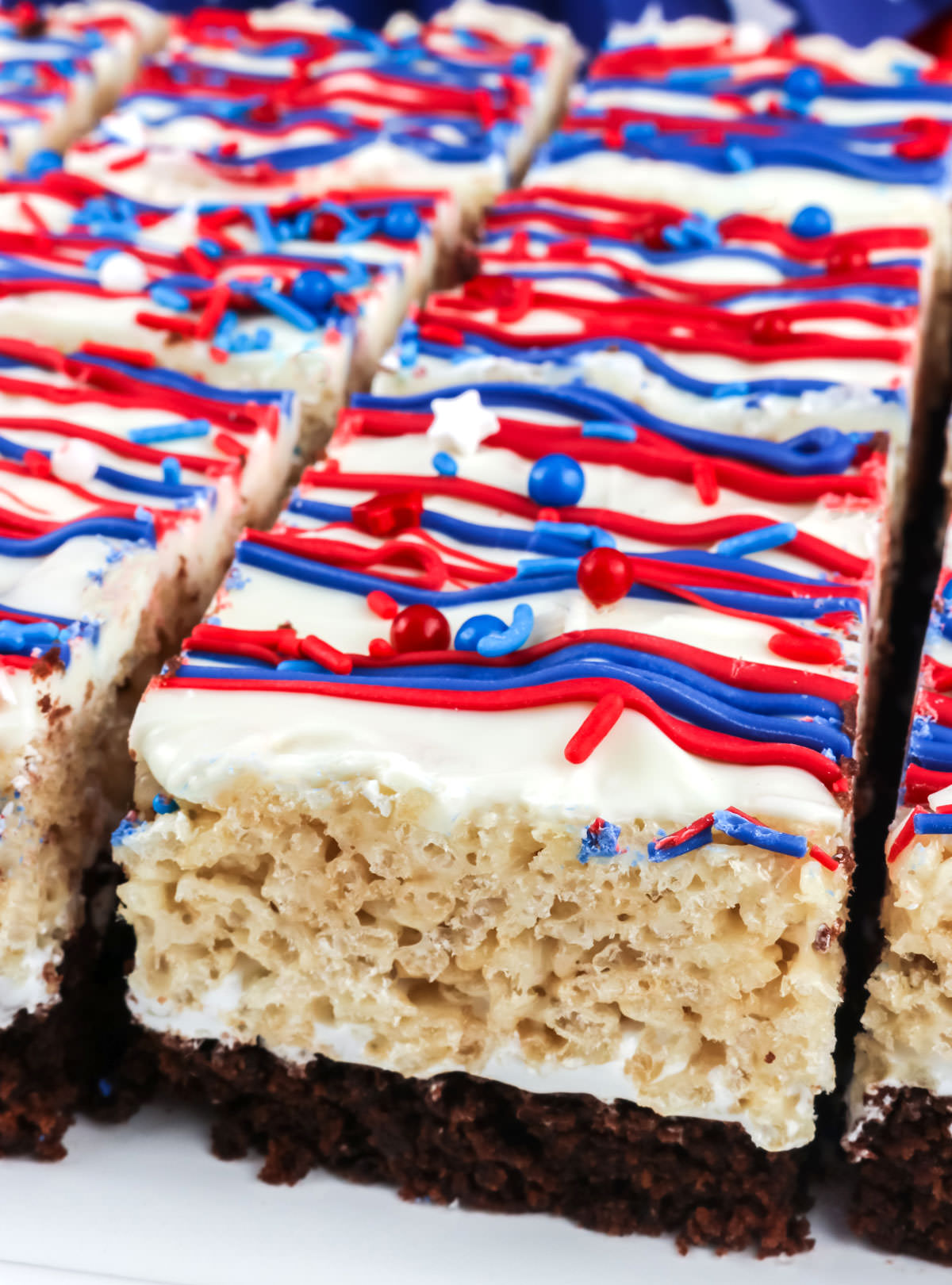 Closeup on a white platter filled with Patriotic Brownie Rice Krispie Treats.