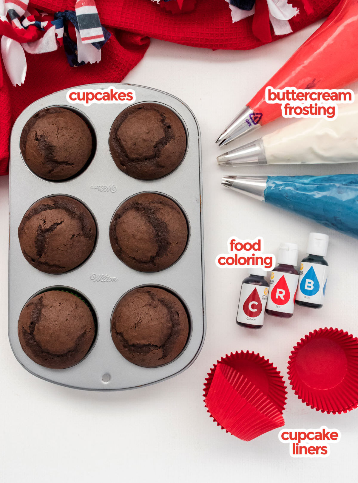 All the ingredients you will need to make Patriotic Swirl Cupcakes including chocolate cupcakes, buttercream frosting, blue and red food coloring and red cupcake liners.