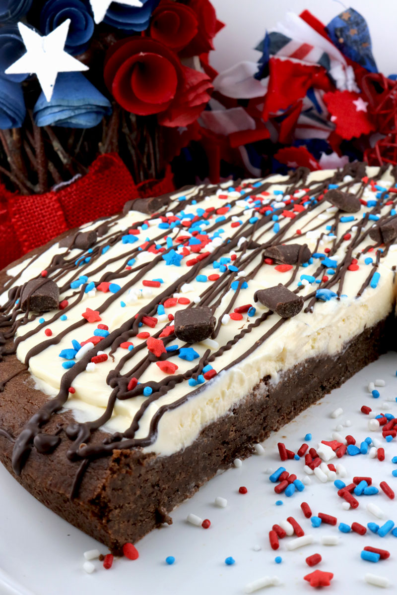 Patriotic Ice Cream Cookie Pizza - a fun and yummy dessert pizza made with chocolate cookie and vanilla ice cream topped with gorgeous red white and blue sprinkles. This Fourth of July dessert will wow the guests at your 4th of July party. Pin this 4th of July treat for later and follow us for more great 4th of July Food ideas. #4thofJuly #fourthofjuly #4thofJulyTreats #4thofJulyDesserts #4thofJulyFoodIdeas