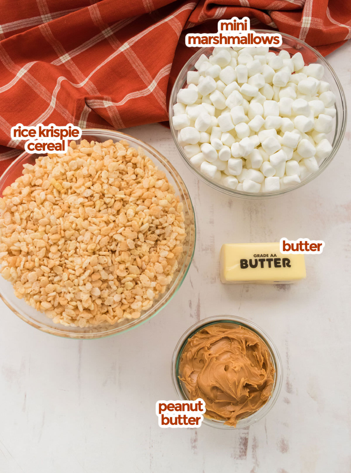 All the ingredients you will need to make Peanut Butter Rice Krispie Treats including Mini Marshmallows, Rice Krispie Cereal, Butter and Peanut Butter.