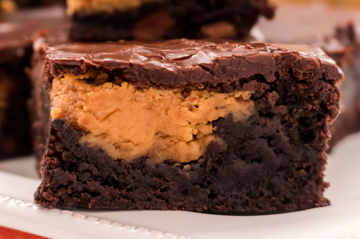 Closeup on a single Peanut Butter Swirl Brownie sitting on a white plate.