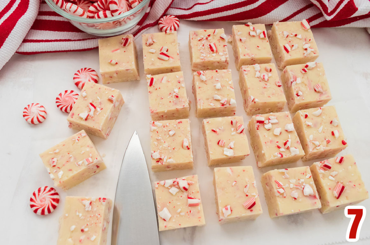 Overhead shot of 20 Peppermint Fudge candies arranged in rows on a white surface surrounded by Peppermint Candies and a knife.