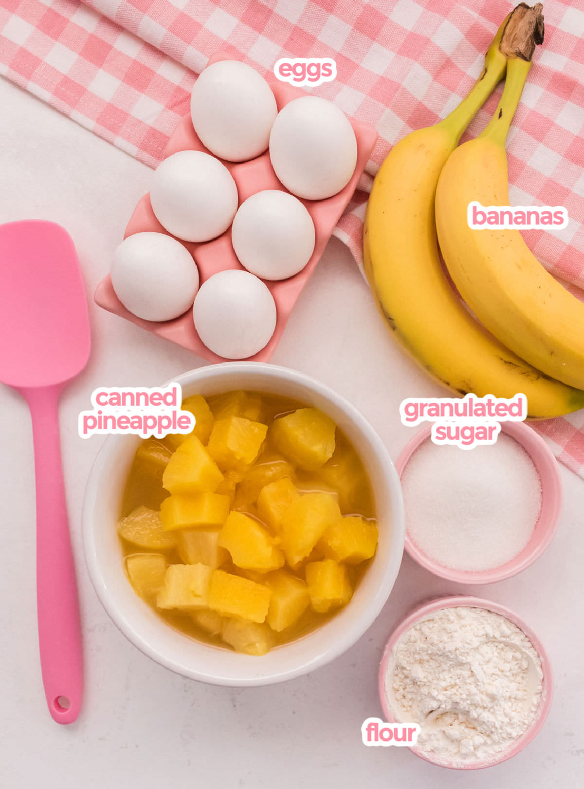 All the ingredients needed to make Pineapple Banana Fluff including Pineapple chunks, Bananas, eggs, granulated sugar and Flour.