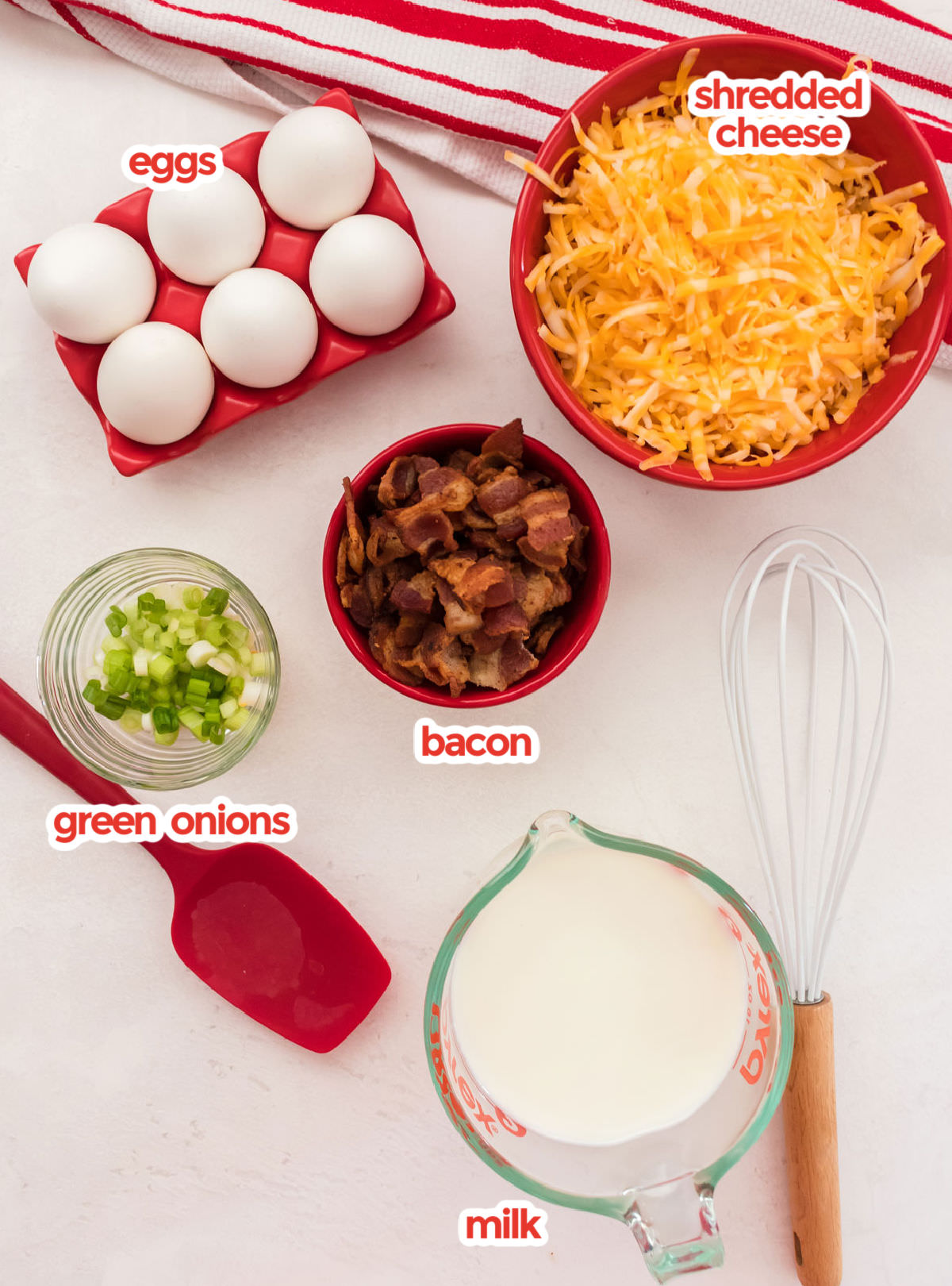 All the ingredients needed to make the Quiche including eggs, cheese, green onions, bacon and milk.