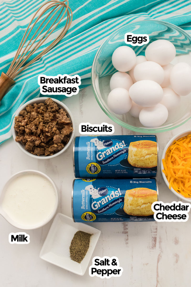image showing all the ingredients necessary to make Sausage Breakfast casserole including biscuits, eggs, sausage, cheese, milk and seasoning.