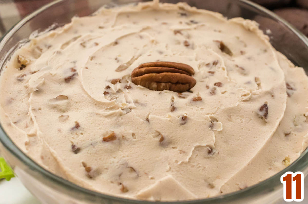 Closeup on a glass bowl filled with homemade Maple Pecan Frosting.