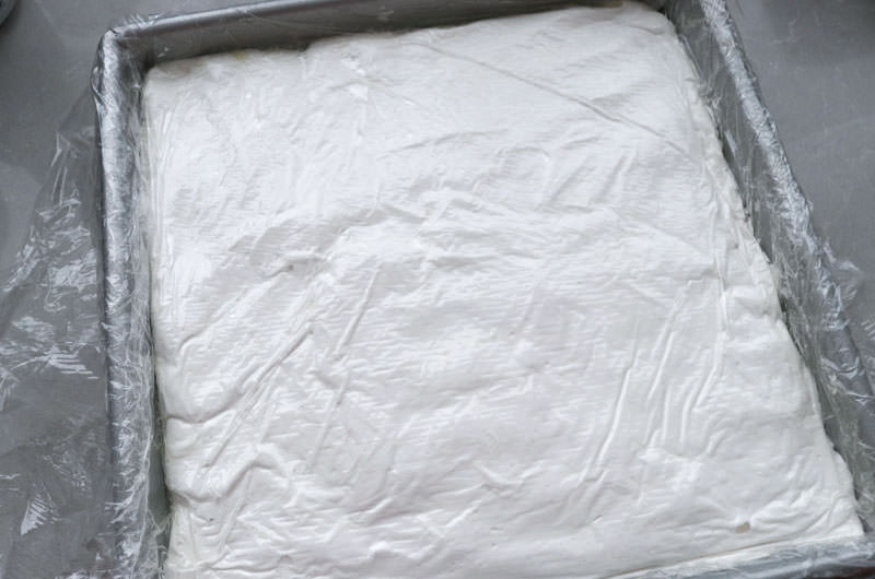 Square baking pan filled with marshmallow mixture